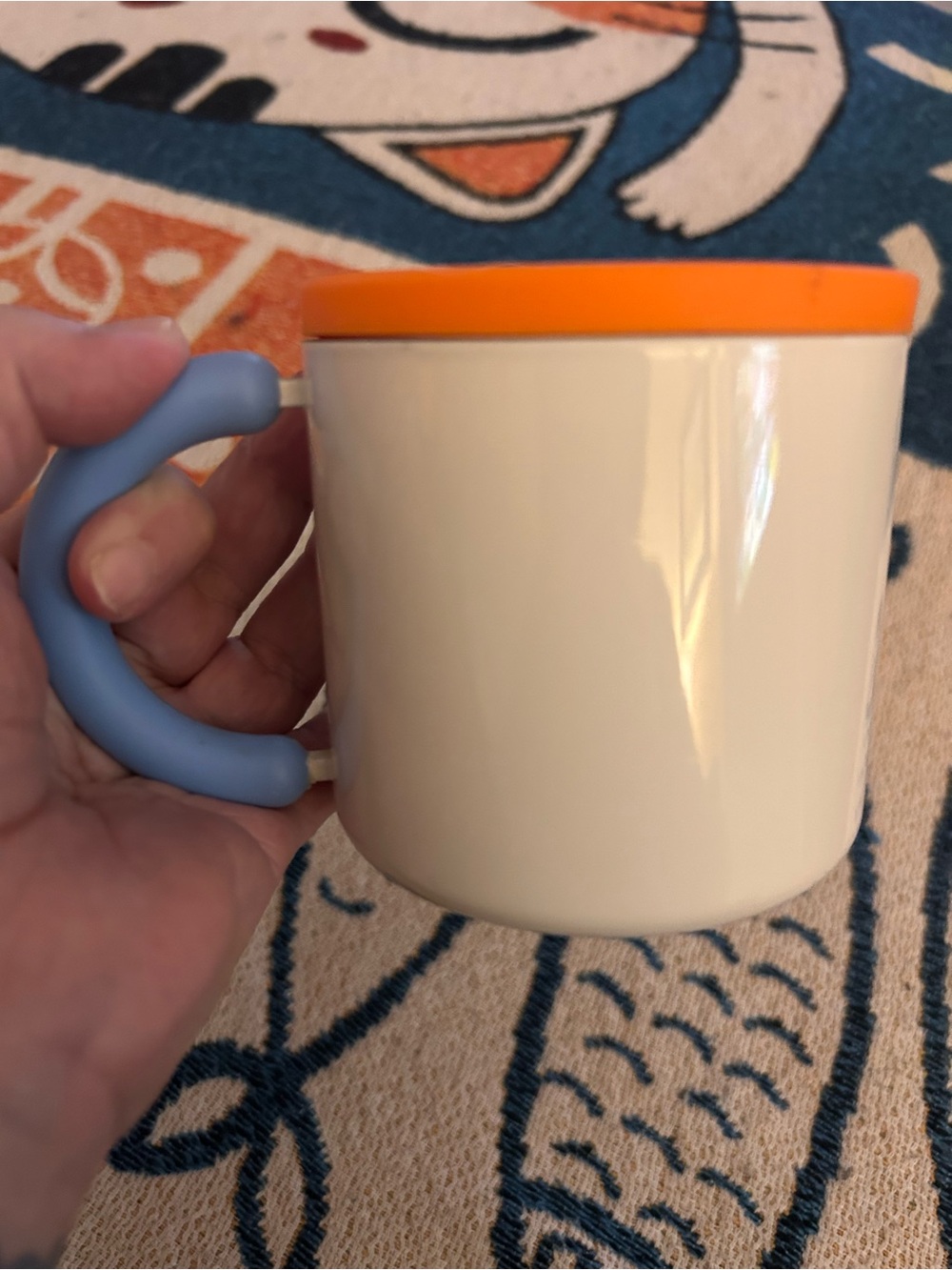 White Mug with Orange Lid and Light Blue Handle